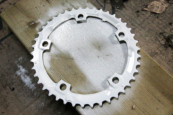 Bicycle chainwheel sprayed with white lacquer